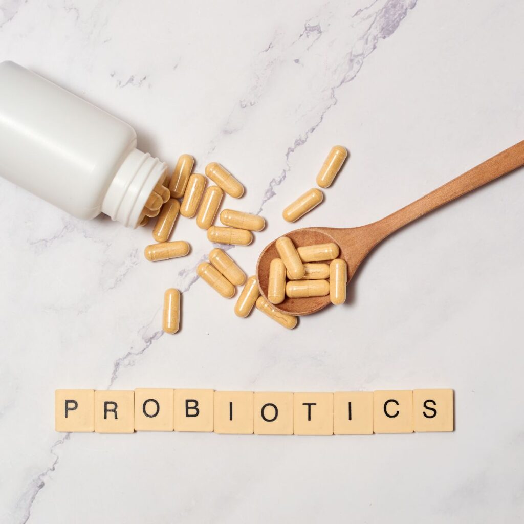 featured image: probiotic capsules with a spoon and a bottle