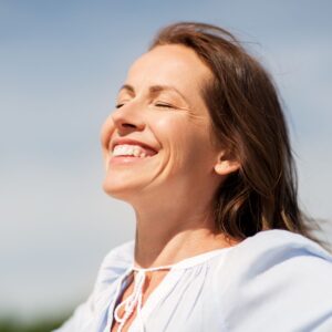 happy woman with sun exposure happy hormones mood
